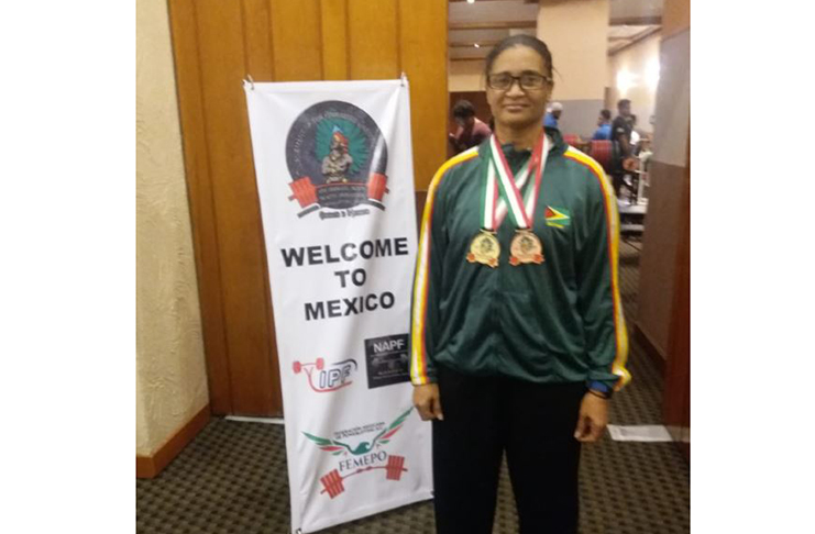 Nadina Taharally poses with her Women’s 72KG Raw Masters 1 Gold and Women’s 72KG Raw Master’s Open Bronze medals.