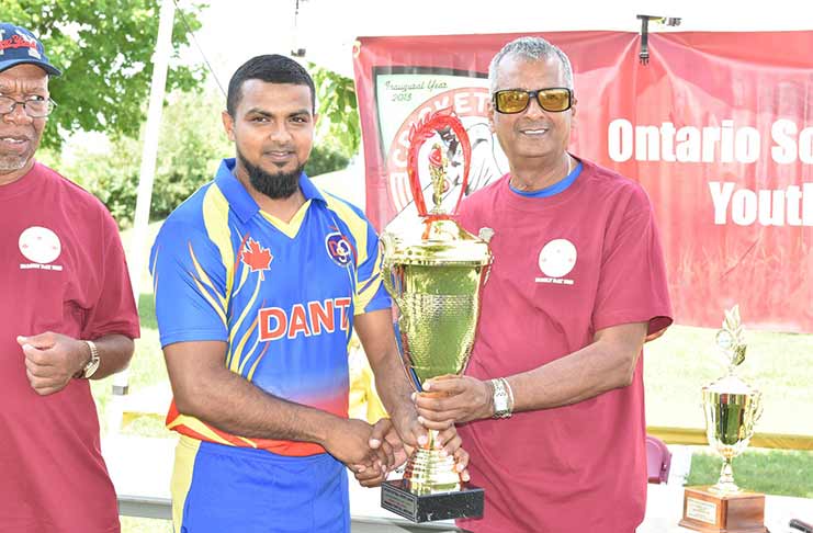 OSCL president Albert Ramcharran (right) hands over the winning trophy to Dant’s Riaz Kadir.