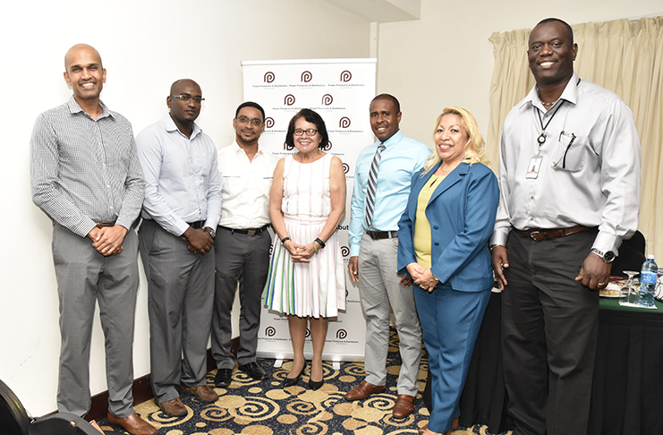 First Lady, Mrs. Sandra Granger shares a photo opportunity with the management team of the company