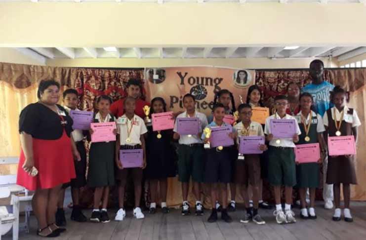 Children who participated in the spelling bee flanked by members of the WCD/WBD branch of the Young Pioneers