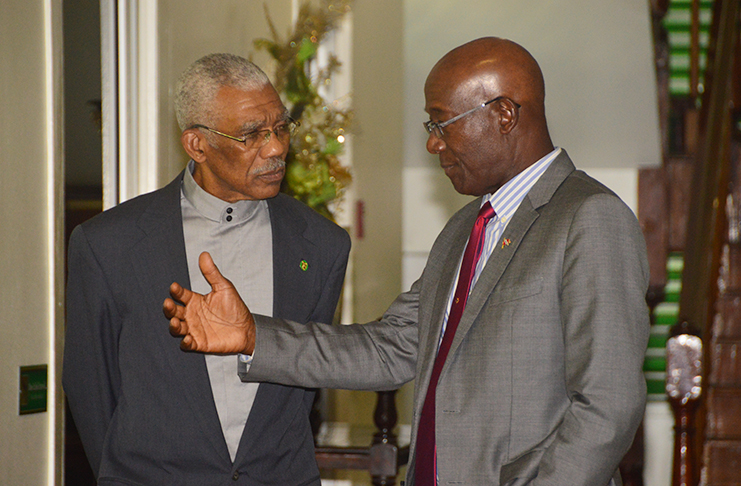 President David Granger and Trinidad and Tobago Prime Minister Keith Rowley engage in private conversation at State House on Wednesday, prior to the signing of the MoU (Adrian Narine photo)