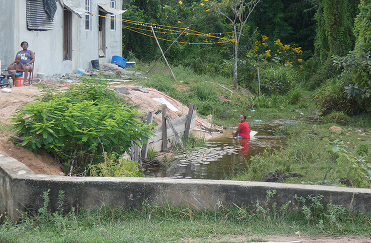 A Kwakwani resident enjoying a late-afternoon soak