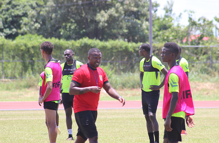 Golden Jaguars head coach Michael Johnson (second from right) during Guyana’s practice session at the National Track and Field Centre. (Rawle Toney photo)