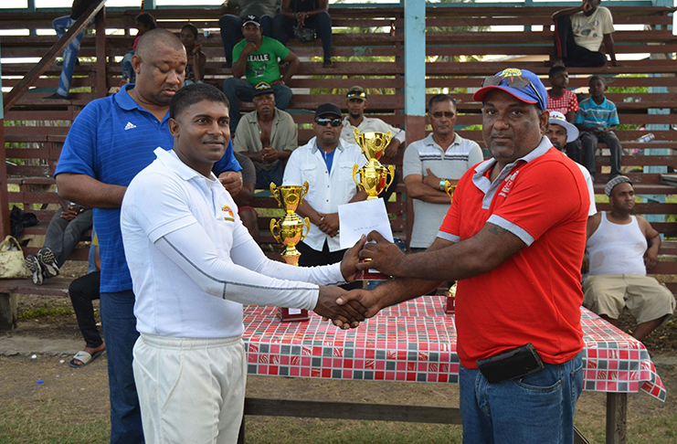 Man-of-the-final, Balram Persaud, receives his award from Yogeshwar Persaud of Sueria Manufacturing.
