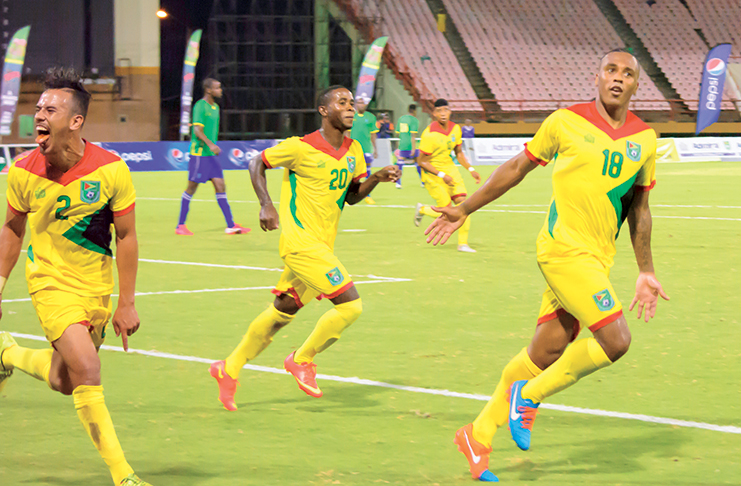 FLASHBACK! Neil Danns (first from left) celebrates after scoring his second goal against St Vincent and the Grenadines at the Guyana National Stadium. Also in photo, from left,  are Samuel Cox and Trayon Bobb. (Samuel Maughn photo)