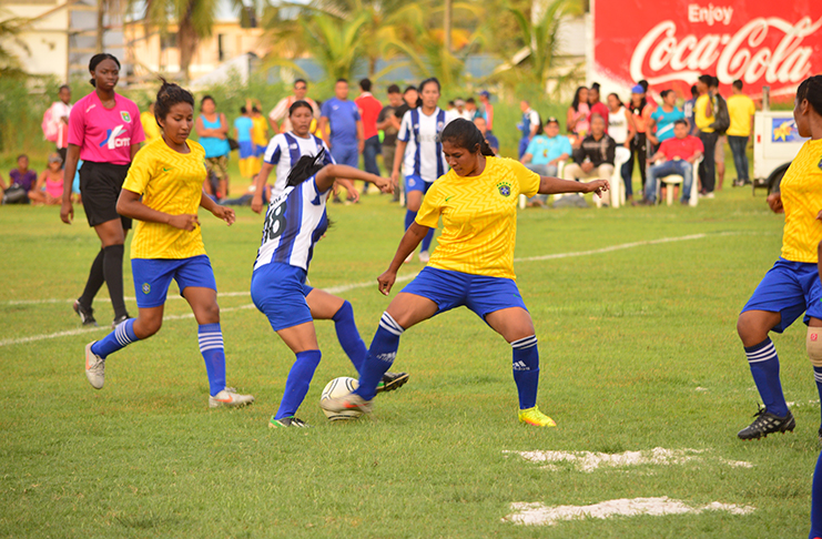 Action in the female football tournament between Paruima (blue) and Siparuta