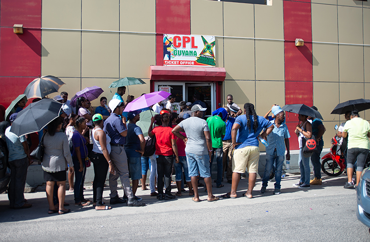 CPL fans line up to get their tickets in front of the Camp and Quamina Street office (Delano Williams Photo)