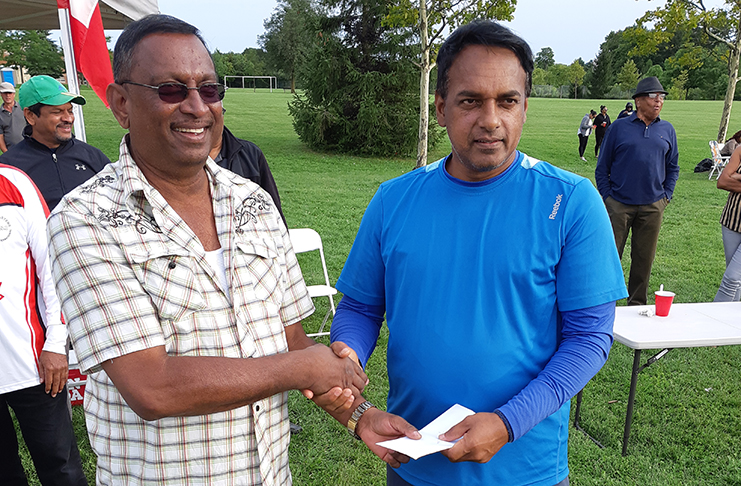 MVP Shivnauth Seeram receives his cash incentive from sponsor Teddy Hussein.