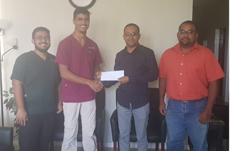 Dr. Pravesh Harry, Director of DIG Inc (second from left) makes a presentation to GSSF treasurer, Mr. Ray Beharry, and GSSF director, Mr. David Dharry (far right). On the left, DIG Inc’s Company Secretary, Dr. Jodah looks on.