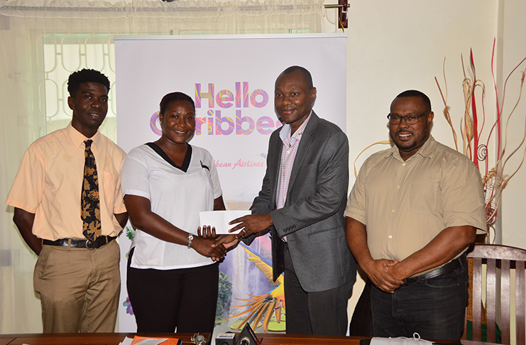 From left, Petra executive Mark Alleyne watches as Jacquiline Boodie collects the sponsorship from Caribbean Airlines’ Dion Innis. At the extreme right is Petra co-director Troy Mendonca. (Adrian Narine photo)