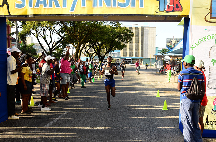 FINALLY! Winston Missigher crosses the finish line ahead of Cleveland Forde, much to the delight of his jubilant supporters. (Samuel Maughn photo)