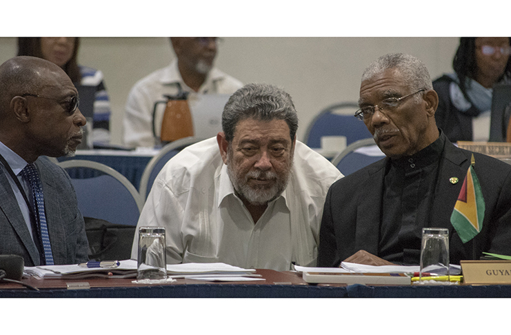 President David Granger makes a point to Prime Minister of St Vincent and the Grenadines, The Hon Ralph Gonsalves as Minister of Foreign Affairs, Mr Carl Greenidge, listens attentively