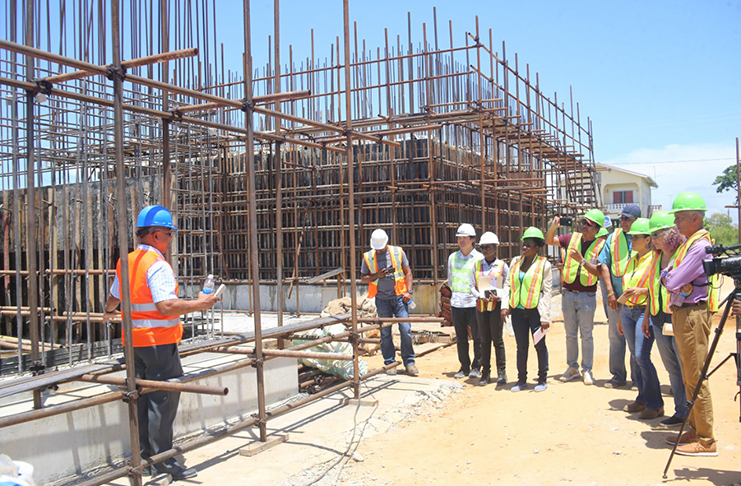 Project Manager, Richard Persaud, (left) explaining works at the water treatment plant site to Minister Ronald Bulkan (right) and others (DPI photo)