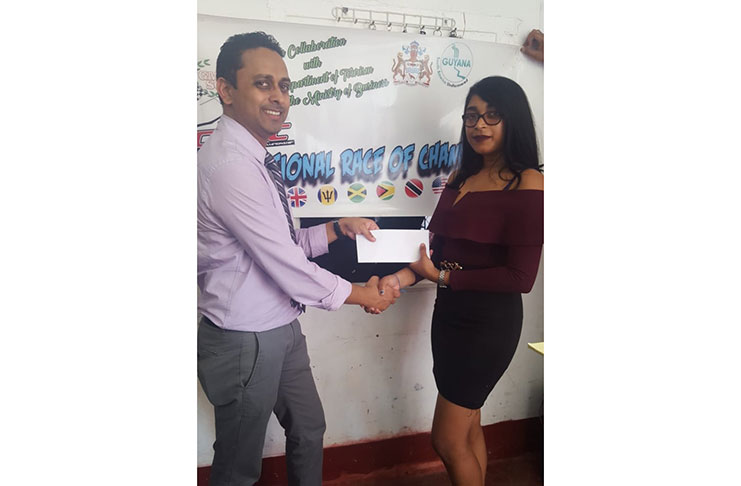 Baishan Kaurlall of Samaroo Investment hands over the cheque to GMRSC’S Surica Singh.