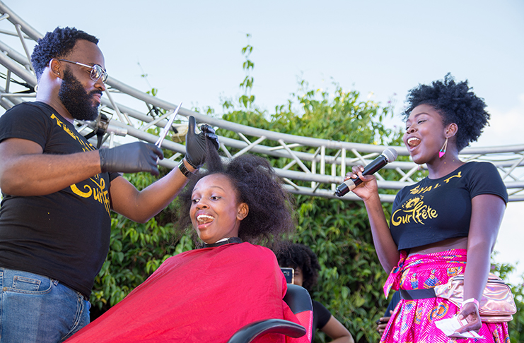 A young woman, Gavrielle Cave did the ‘BIG CHOP’ at Curl fete 2018, where she had her hair cut off in front of thousands of people as she aimed to ‘go natural’. At right is Curl Fete co-founder, Tamika Henry