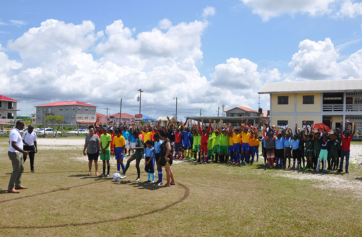 One of the many female players in the U-11 league, Timehri Panthers’ Jamika Medouze, accepts the ball from GFF president Wayne Forde to officially start the league on Saturday.