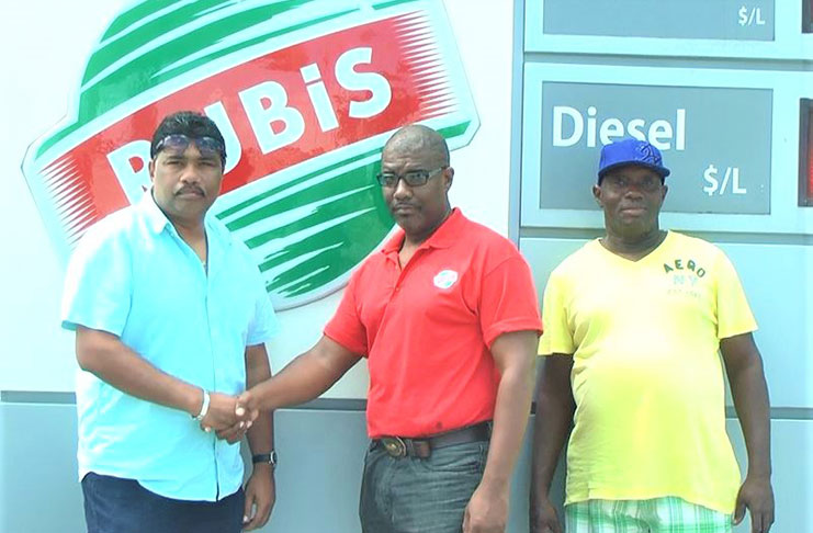 GFSCA’s Anil Beharry (left) and another official with the RUBIS representative