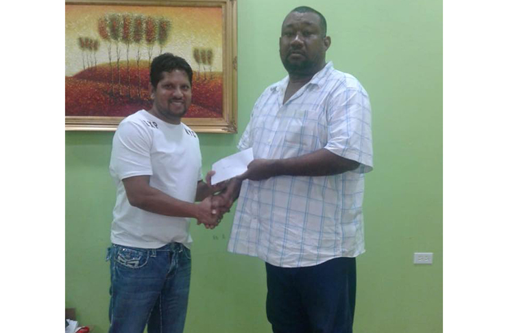 Former West Indies captain hands over the sponsorship cheque to BCB president Hilbert Foster.