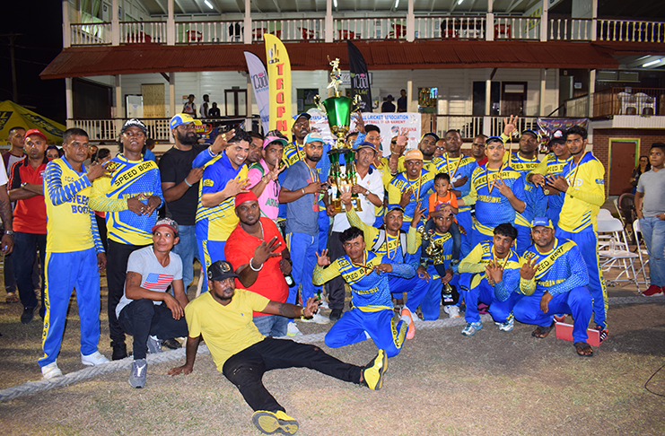 GFSCA president Ramchand Ragbeer hands over the winning trophy to Ariel Speedboat captain, Wazeer Mohamed, in the presence of jubilant players and supporters.