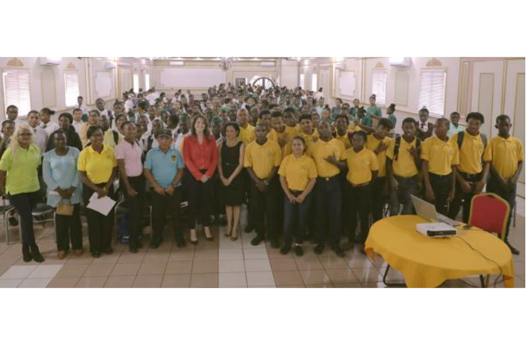 Deedra Moe, Senior Director Public & Government Affairs at Exxon Mobil (sixth from left) and Goldie Scott, CEO of VYC Volunteer Youth Corps (third from left) pose with students of the VYC