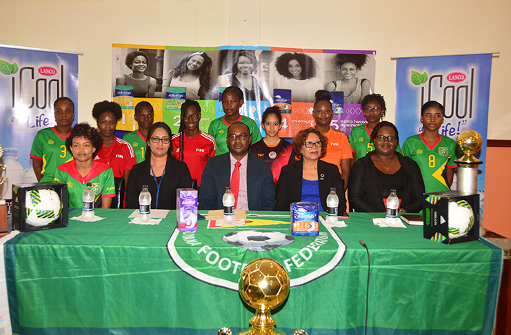 Ansa McAl’s Head of Business Unit Padma Kunjbeharry (second from left), GFF president Wayne Forde, Minister within the Ministry of Indigenous Peoples’ Affairs Valerie Garrido-Lowe and president of the women’s football association, Andrea Johnson, are flanked by players at the launch of the GFF ‘Always’ Nation-wide women’s football league. (Adrian Narine photo)