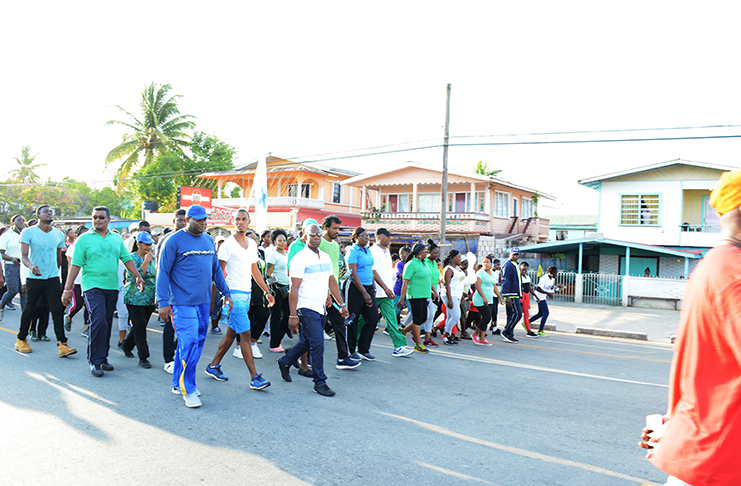 Commander Edmond Cooper (extreme left in front with cap); Minister of State, Joseph Harmon; Deputy Commissioner of Police, Maxine Graham and other senior police officers; President of the Region Three Chamber of Commerce, Halim Khan, can be seen leading the march.