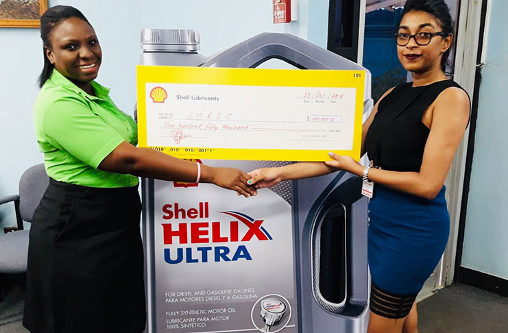 SOL's Thandi Bryan (left) hand over her company's sponsorship to GMRSC's Surica Singh during a simple presentation yesterday.