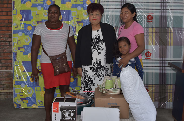 Minister of Social Protection, Ms. Amna Ally (centre) with two victims of Sunday's fire.