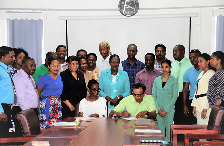 Two of the master trainers signing their contracts in the presence of colleagues, Education Minister Nicolette Henry, Permanent Secretary Adele Clarke and GESIP Project Coordinator, Jimmy Bhojdat