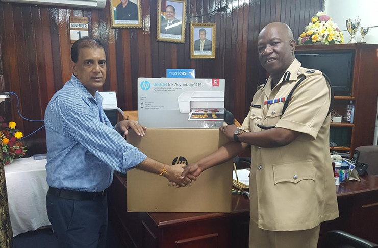 Businessman Cobeer ‘Anand’ Persaud hands over the supplies to Divisional Commander Assistant Commissioner Marlon Chapman