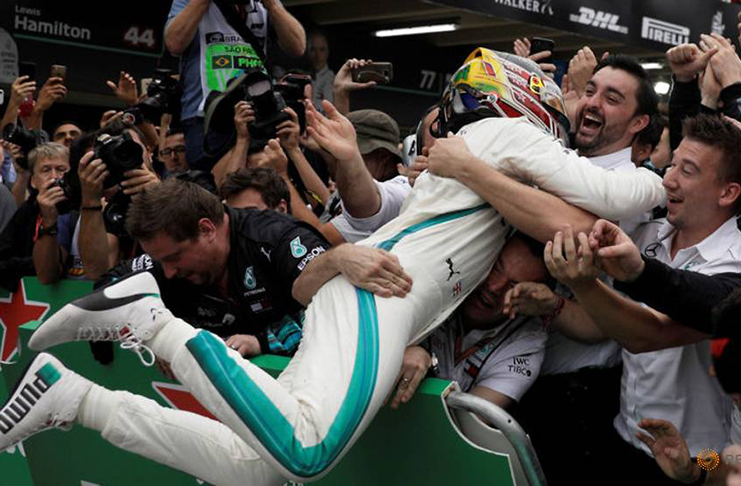 Mercedes' Lewis Hamilton celebrates with team members after winning the race. (REUTERS/Ricardo Moraes TPX IMAGES OF THE DAY)