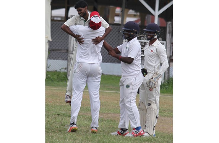 DCC captain Christopher Barnwell lifts Totaram Bishun after one of his dismissals.
