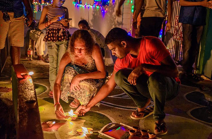 Members of the Sukar family of Campbellville, Georgetown, lighting diyas as they celebrate
Diwali (Delano Williams photo)