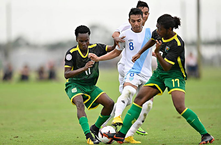 Guyana’s Kelsey Benjamin (left) and Jalen Case battle Guatemala captain Rudy Barrientos for ball possession during their CONCACAF U-20 Championship fixture yesterday, in Florida, USA. (Photos compliments: CONCACAF)