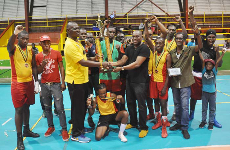 FLASHBACK! GDF’s Terrence Poole receives the ‘Best Gym’ trophy from GBA president Steve Ninvalle at the conclusion of last year’s Terrence Alli National Open Championship. (Photo compliment: Kaieteur News)