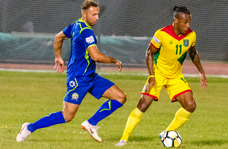 FLASH BACK! Barbados’ Hallam Hope (right) about to challenge his former Bury FC teammate Neil Danns during the 2 – 2 clash between Guyana and Barbados in the CONCACAF Nations League at the National Track and Field Centre. (Samuel Maughn photo)
