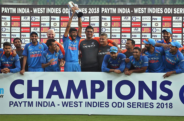 Members of the Indian cricket team celebrate with the winners’ trophy after their victory over West Indies in their fifth and last one-day international in Thiruvananthapuram,