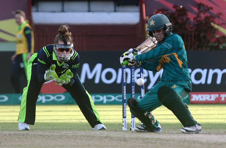Pakistan’s Javeira Khan gets ready to smash one through the offside as Ireland’s Mary Waldron watches. (Adrian Narine photos)