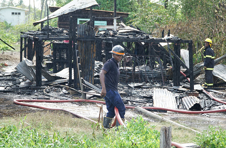 A fireman and his colleague mopping up after the fire