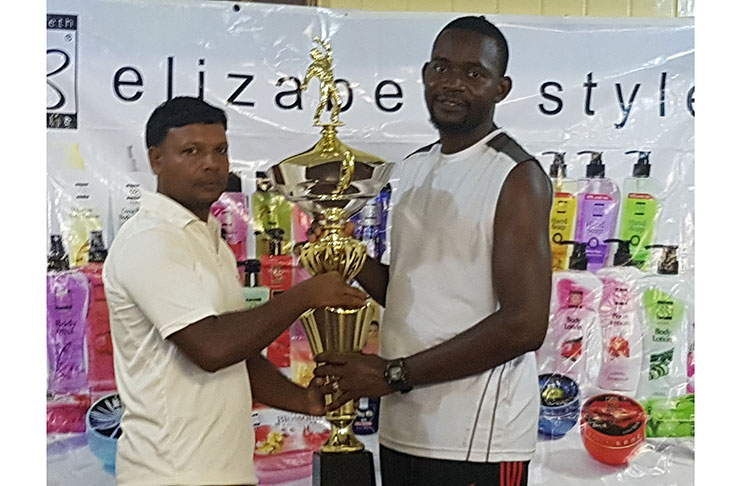 Captain of Better Hope Cricket Club, Clive Rampersaud and captain of Buxton ‘Carl Hooper’ Sports Club, Marvin Cato, pose with the prestigious Elizabeth Styles championship trophy.