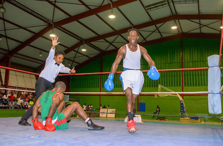 FLASHBACK! GDF’s Rhondell Douglas is issued a mandatory eight-count by referee Romona Agard during his lightweight fight against Rose Hall Jammers’ Joel Williamson, during the 2017 Terrence Alli National Open Championships. Williamson was subsequently named Best Elite boxer. (Samuel Maughn photo)