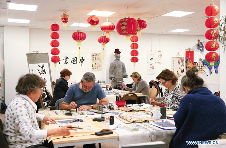 Students write Chinese calligraphy at the Confucius Institute in Brussels, Belgium