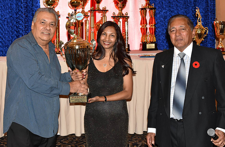 Ed Pestano, captain of the inaugural winning Over-60 team collects the Nascup, sponsored by businessman Nasser Baksh. At right is OMSCC president Azeem Khan.