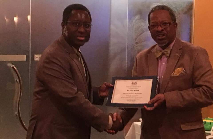 Being presented with a certificate in 2017 from Vice-Chancellor Ivelaw Griffith, making him an Educational Resource Ambassador for the University of Guyana