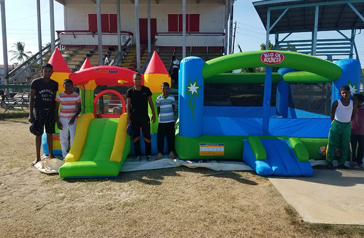 Club members pose with the Bouncy Castles donated to the RHTYSC by Lindon Lewis and Ravi Singh.