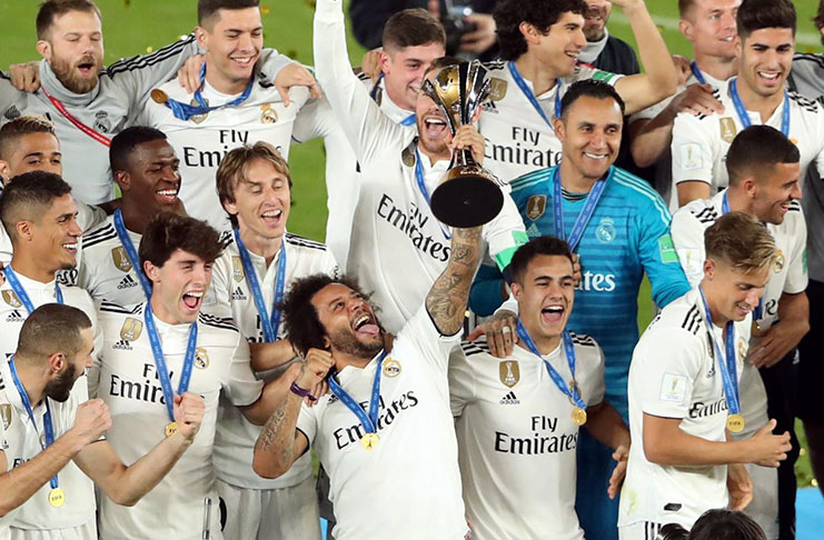 Real Madrid players celebrate with the trophy after winning the Club World Cup. (REUTERS/Ahmed Jadallah)