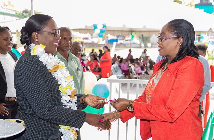 Minister of Education, Dr. Nicolette Henry formally hands over the keys to Headteacher of the Smyth Street Nursery, Ms. Charmaine Benjamin