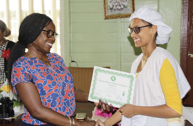 Deputy Chief Medical Officer Dr. Karen Boyle presenting one of the graduates with her certificate
