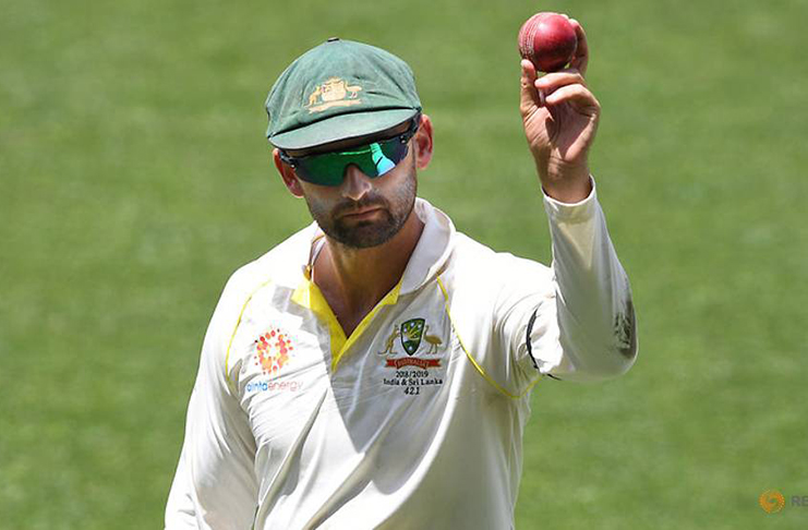 Australia's Nathan Lyon shows the ball as he leaves the field following his 6-wicket haul on day four of the first Test match against India at the Adelaide Oval in Australia, December 9, 2018. (AAP/Dave Hunt/via REUTERS)