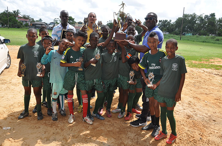 Captain of champions Timehri Panthers, Omar Sam, collected the winners’ prize from Franklin Wilson in the presence of his excited clubmates